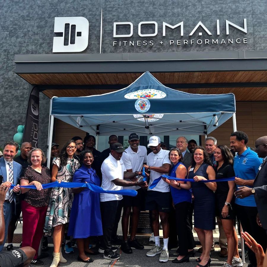 Ribbon-cutting with business partners, county and state officials outside of Domain Fitness + Performance.