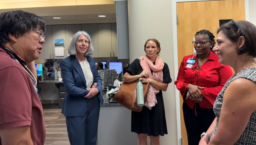 Council President Stewart, PCC representatives and health care providers chat during a tour of Holy Cross Center.