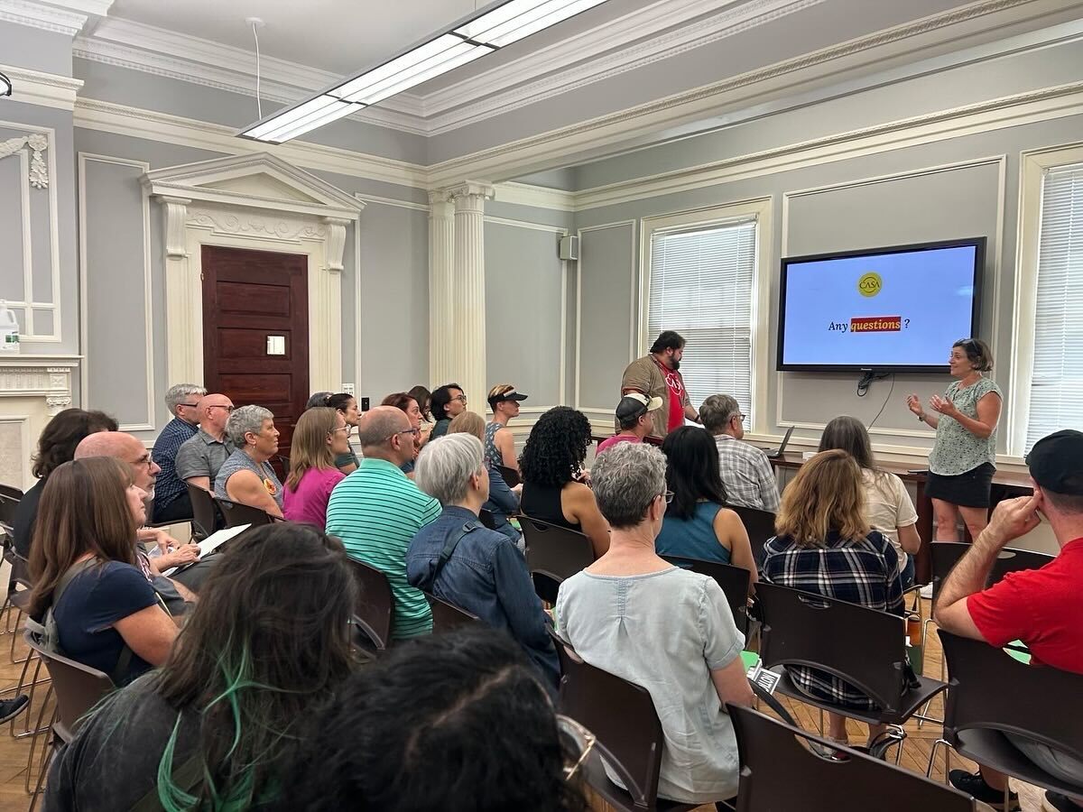 Council President Stewart presents to a room of CASA volunteers and community members.