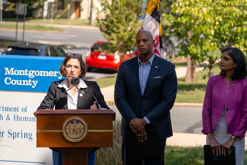 Council President Stewart speaks at a podium standing beside Gov. Wes Moore.
