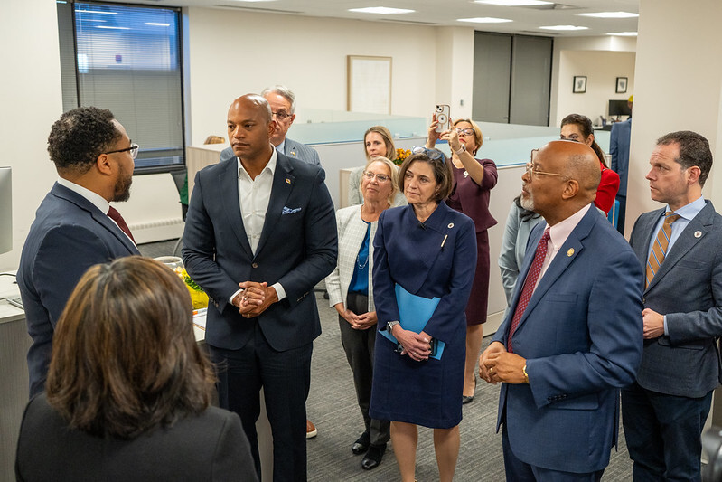Governor Wes Moore, Council President Kate Stewart gathered around with Councilmembers and staff.