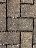 Porous pavers with leaf debris that should be vacuumed out