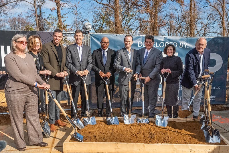 County and housing leaders hold shovels for the Chimes groundbreaking event.