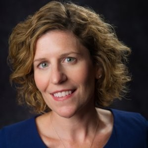 headshot of lady with blonde brown hair and a blue shirt