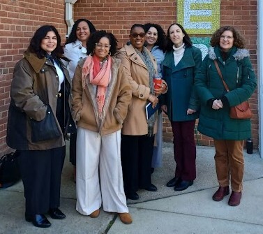 Presenters in coats outside MCPS building on a cold day