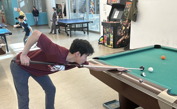 Playing billiards at rec center game room