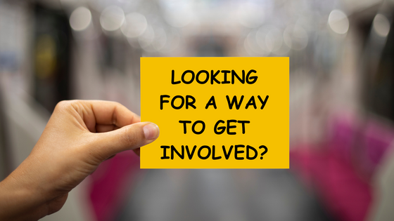 Hand holding a sticky note that reads "looking for a way to get involved?"