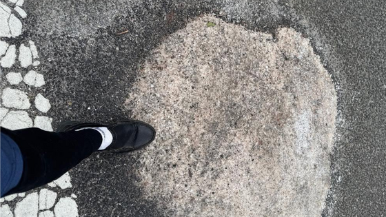 Person stepping on a salt pile.