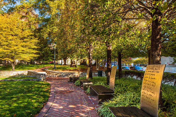 A photograph of the 9/11 memorial benches in Rockville, each inscribed with names of victims.