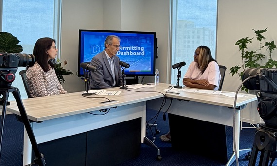 dps podcast taping with three staff members talking about permitting dashboards at a table with microphones