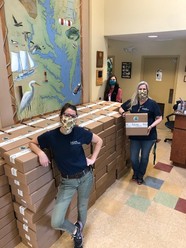 Living Classroom Foundation members stand with 250 completed take-home kits