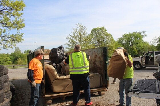 Trash Cleanup volunteers loading dumpster
