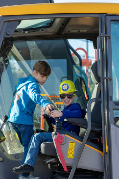 Kids sitting in construction vehicle