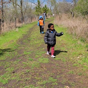 Family walking the trails of Masonville Cove