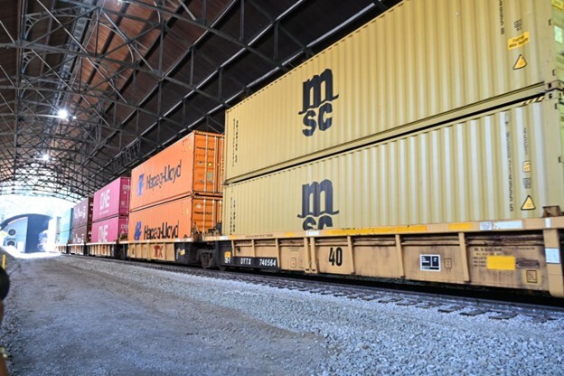 Double stacked shipping containers on a railcar.