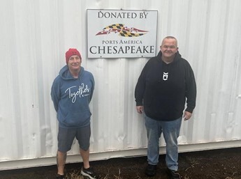 Eddie Durchlag and Billy Humphrey stand by the refurbished 40-foot container donated by PAC.