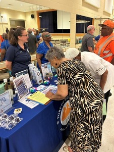 people gathered at a table learning about the port of Baltimore and dredging