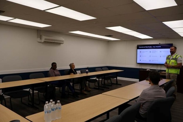 Four graduate students from the JHU Bloomberg School of Public Health at a stop along an educational tour of the Port of Baltimore.