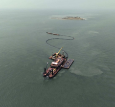 Photo of a large boat and crane floating next to James Island.