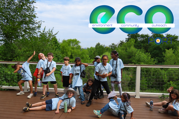 Group of children playing on an outdoor deck during Youth Birding Week at Masonville Cove. 