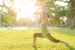 Photo of woman stretching outside on a sunny day.