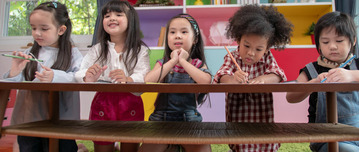 Young children listening and engaging in classroom setting.