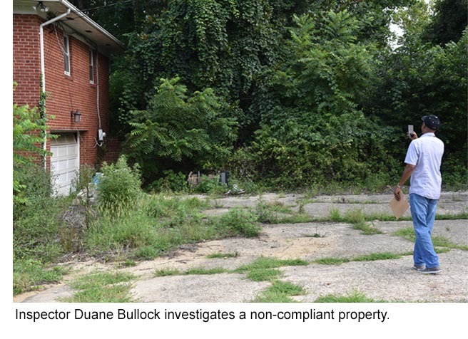 Inspector Duane Bullock investigates a non-compliant property (weeds, trash).