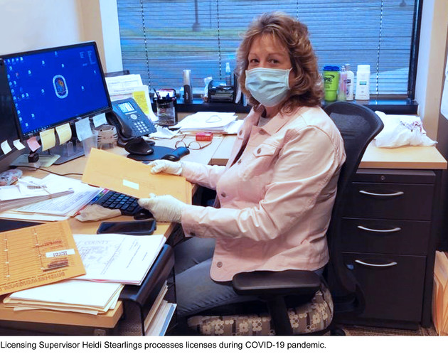 Licensing Supervisor Heidi Stearlings processes licenses during COVID-19 pandemic.