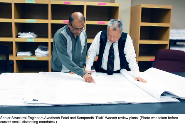 Senior Structural Engineers Avadhesh Patel and Sompandh “Piak” Wanant review plans. (Photo was taken before current social distancing mandates.)