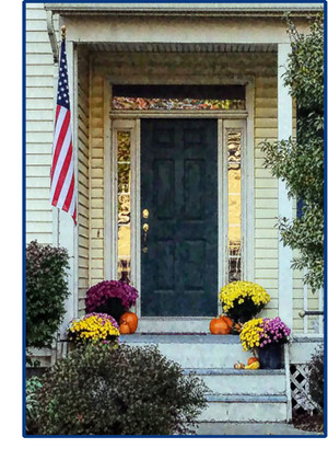 Fall mums on stairs, door needs paint and house needs cleaning up