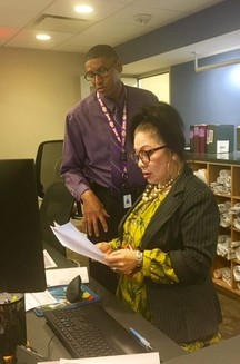 Demetrius Jones, Permits Center , reviews a document with staff member Lilliana Escobar.