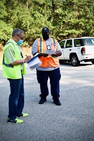 Inspectors Ricardo Smith and David McLaurin prepare to deliver information to Laurel residents.