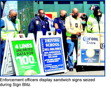Group of inspectors with sandwich signs during sign blitz