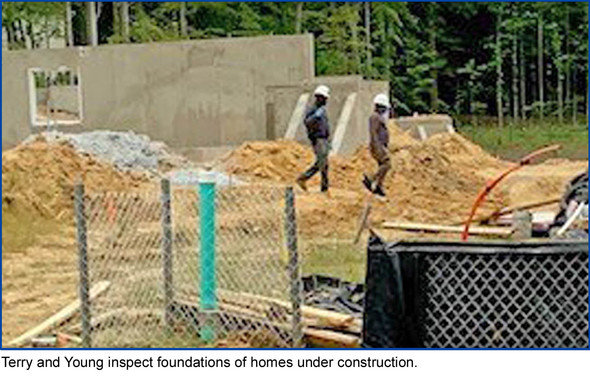photo of 2 inspectors checking slabs. Terry and Young inspect foundations of homes under construction.