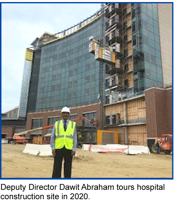 Dawit in front of hospital - Deputy Director Dawit Abraham tours hospital construction site in 2020.