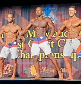 Eric Wardford, winner, and 2 competitors in bodybuilding competition