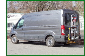 Photo of work van parked in front of a residential home