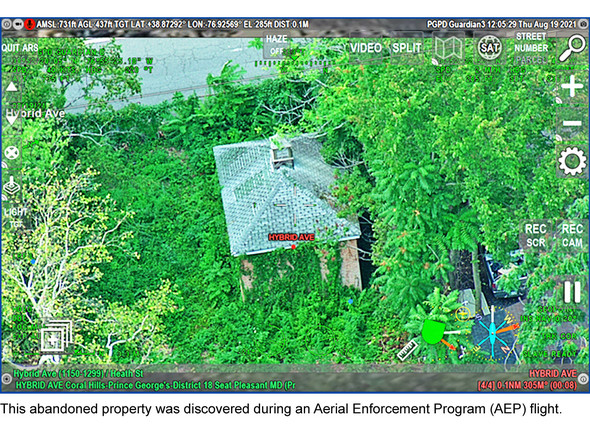 This abandoned property was discovered during an Aerial Enforcement Program (AEP) flight. pic of overgrown vegetation covering house and property