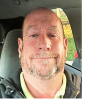 Donald Smith, newly promoted Inspections employee, selfie in car while parked