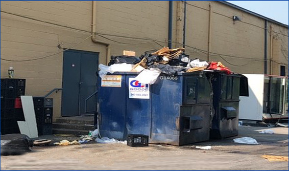 shopping center’s owners cited for 15 code violations, including this overflowing dumpster