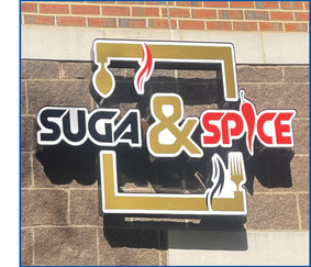 Suga & Spice's logo on brick building in Hyattsville
