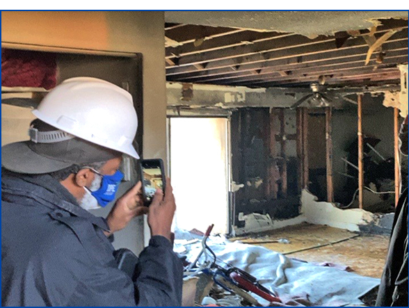 Inspector Christopher Scott documenting unsafe structure after fire damage