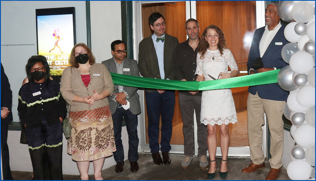 The ribbon cutting symbolizing the reopening of the Old Greenbelt Theatre portrays a new chapter for the iconic theater