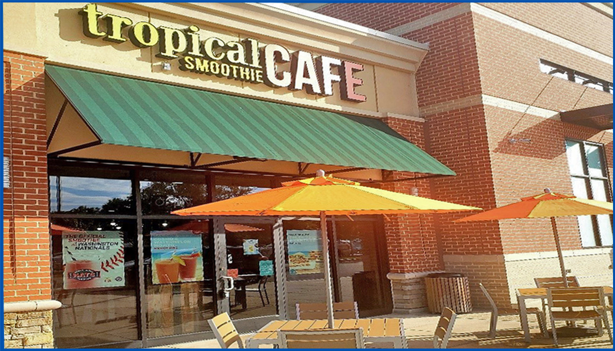 Tropical Smoothie Cafe front of establishment with umbrella tables and chairs