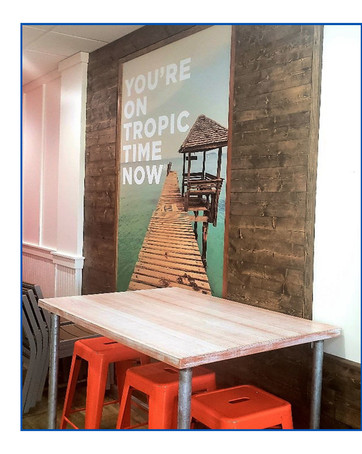 Interior photo of Tropical Smoothie Cafe showing board with You're on Tropic Time Now saying
