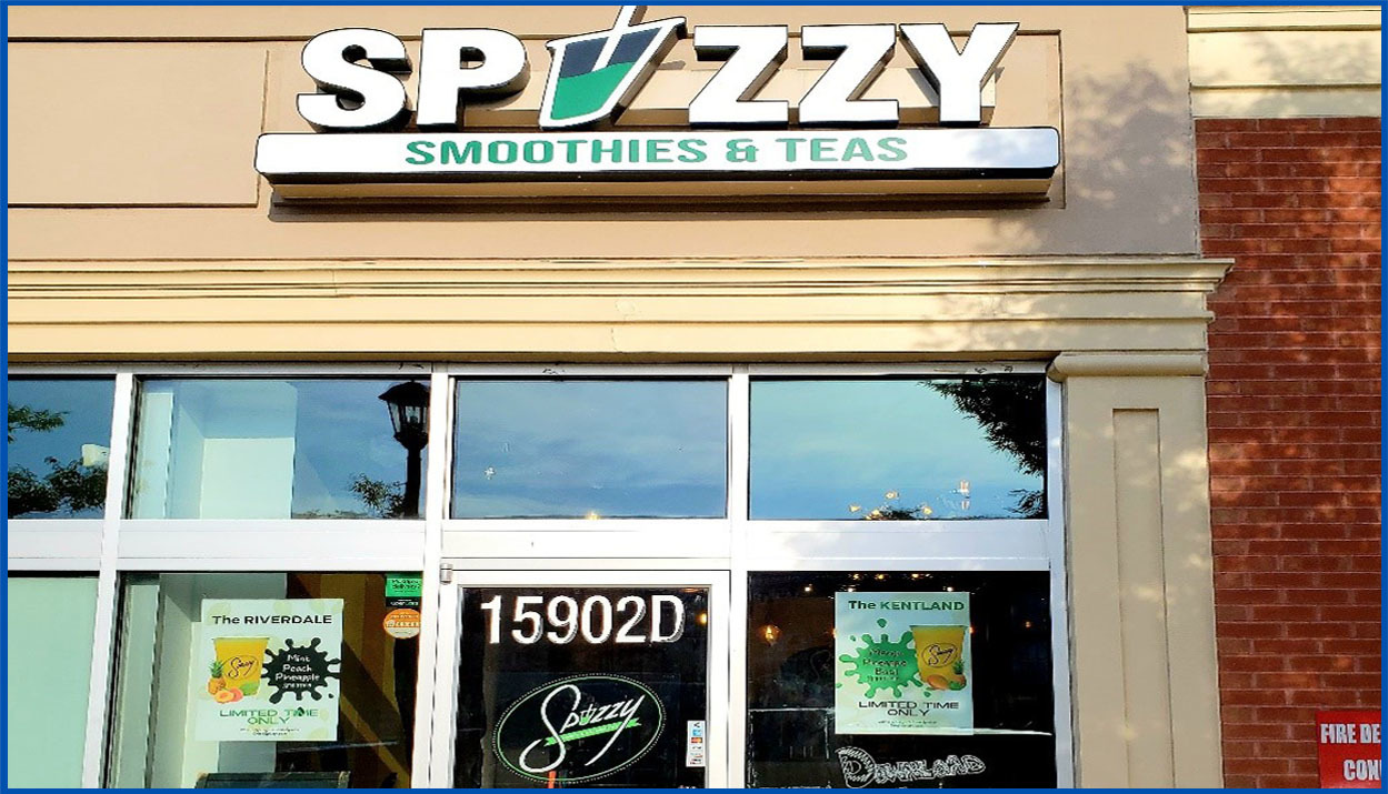 Spizzy Smoothies and Teas exterior of brick building with logo feature cup with straw as the letter "i"