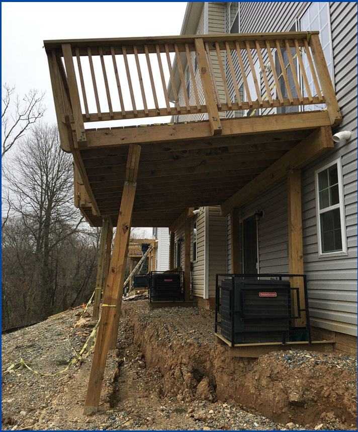 Decks falling due to slope failure and ground pulling away from foundations of some of the townhouses. 