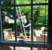 Homeowner on ladder to fix house for spring compliance
