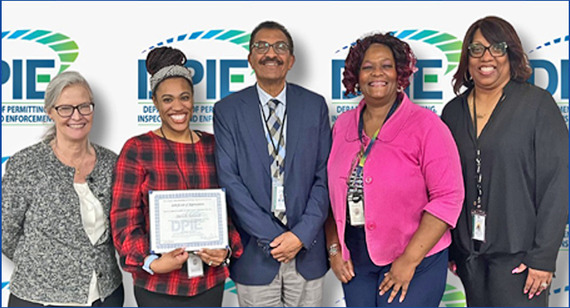 Danielle Robinson is honored with certificate, photo with DD Giles, Director Abraham, AD Spears, Permitting Office Manager Ms. McLean.