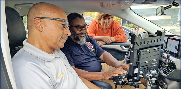 Code Enforcement officers on site, working out of their County vehicle to answer a citizen complaint.